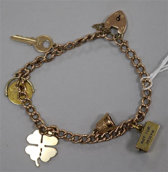 A 9ct gold charm bracelet with padlock clasp hung with five charms, three 9ct, one 14K and one unmarked